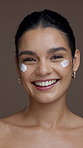 Skincare, laugh and face of woman with cream for moisturizing, anti aging and hydration. Dermatology, studio background and portrait of person with lotion cosmetics for beauty, benefits and health