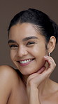 Skincare, happy and face of woman in studio with glowing skin, hydration and natural beauty. Smile, person and results of cosmetics treatment on brown background for dermatology or self care routine