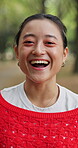 Face, laughing and travel with Asian woman outdoor in nature for break, comedy or journey. Adventure, funny and happy with Japanese person in forest or woods for holiday, tourism and vacation