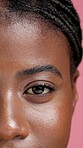 Face, black woman and eye for beauty in studio with makeup, natural lashes and aesthetic. Portrait, closeup and person with cosmetics for change, facial flow and laminated eyebrows on pink background