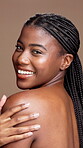 Happy woman, face and touch shoulder for beauty in studio, dermatology or smooth texture on brown background. Treatment, shine and skincare portrait with African person, skin health and self care