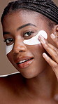 Face, black woman and eye mask for skincare, beauty or glow on brown studio background. Portrait, cosmetics and model with gel patch for detox, dermatology and happy with facial treatment application