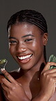 Skincare, gua sha and jade roller with face of black woman in studio for lymphatic drainage, self care or detox. Facial tools, holistic and beauty with person on dark background for circulation