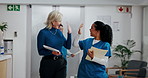 Happy, colleagues and high five for good news, hospital and success for healthcare, nurse and women. Celebration, gesture or people with smile for achievement in clinic, administrator and specialist