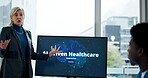 Hospital, presentation and woman with monitor, meeting or explaining ai driven healthcare or screen. Clinic, people and administrator with info for new tech, discussion and plan for automated systems
