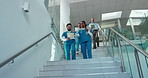 Hospital, talking and nurse team on stairs for consulting, feedback and diagnosis results. Healthcare, clinic and people walking with paperwork in discussion for medical help, teamwork and advice