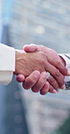 City, colleagues and handshake for agreement, collaboration or gesture business deal or partnership. Achievement, employee and shaking hands for teamwork, people and outdoor for meeting or success