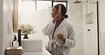 African woman, hair brush and mirror in bathroom with grooming routine, self care and profile in home. Person, hairstyle and results with keratin treatment, benefits and growth with texture at house