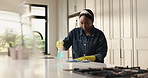 Woman, spray and cleaning counter in kitchen for surface disinfection, dust removal or housekeeping. Maid, black person or wipe bacteria with gloves in home for domestic chores, hygiene or sanitation