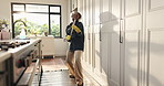 Broom, headphones and black woman dance in home for cleaning, floor maintenance and hygiene in living room. Happy, air guitar and person listen to music for housekeeping, dust and sweeping with fun