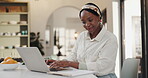 Home, laptop and black woman with finance paperwork for online banking, account and tax info. Typing, documents and person on computer for digital accounting, financial planning and budget with bills