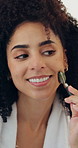 African woman, jade roller and skincare by bathroom mirror in home with smile, circulation or results. Person, happy and beauty with tools for health, benefits and dermatology in morning at house
