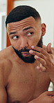 Skincare, house and man in bathroom, check and treatment for beard, clear skin and grooming. Apartment, cosmetics and person with dermatology, smooth and texture with aesthetic, shine and routine