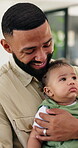 Home, dad and man with baby, love and bonding with child, happy or affection in living room or care. Single parent, father or person with infant in lounge, boy or smile for growth of newborn in house