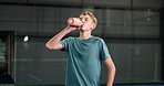 Break, drinking water and padel with boy on court for child development, exercise or training. Fitness, hydration and recovery with kid in health club or sports venue for course, lesson and workout