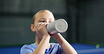 Break, drinking water and padel with girl on court for child development, fitness or training. Exercise, hydration and recovery with kid in health club or sports venue for course, lesson and workout