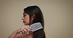Hairbrush, beauty and woman in studio for self care, texture and health with growth. Hairstyle, cosmetics and model with paddle brush for grooming, salon or scalp exfoliation for shine on background