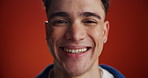Man, face and laugh in studio closeup, confidence and pride with smile on red background. Gen z person, happy and excited in portrait with expression, funny joke and silly with humor in Costa Rica