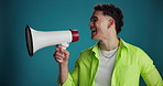 Megaphone, excited and man in studio for news, discount announcement and sale notification. Communication, mockup and person with bullhorn for information, promotion and choice on blue background