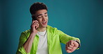 Phone call, man and check watch in studio for meeting schedule, appointment reminder and update. Mockup space, person and talking to contact on blue background for planning, time management and chat