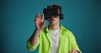 Futuristic, simulation or man with VR headset in studio for interactive gaming, UX and innovation. AR vision, gamer and 3D glasses on blue background for metaverse, virtual reality or user experience
