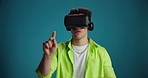 Futuristic, click or man with VR headset in studio for interactive gaming, selection or simulation. AR, gamer and swipe with 3D glasses on blue background for metaverse, virtual reality or technology