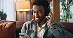 Dance, music and phone with man on sofa for streaming, songs playlist or relax. Audio subscription, calm podcast and connection with person in living room of home for album, headphones and listening