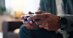 Person, hands and playing games with controller in home for esport, entertainment or subscription. Closeup, gamer or console with remote for competitive gaming, online action or electronic adrenaline