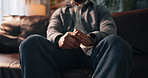 Man, anxiety and nervous hands with stress on sofa for panic, overwhelmed or mental health in home. Closeup, male person or fidget with pressure for panic, substance withdrawal or trauma in house