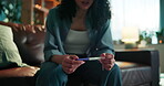 Hands, woman or stress with pregnancy test on sofa for negative results, bad news and IVF fail. Disappointed, girl or upset with stick outcome in home for infertility, ovulation planning or disbelief