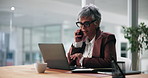 Laptop, phone call and businesswoman in office with research for finance budget proposal. Reading, technology and mature female financial manager working on investment report for client in workplace.