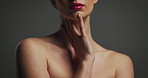 Woman, hands and makeup with lipstick for cosmetics, skincare or beauty on a gray studio background. Female person, model or treatment with skin tone or glow up for dermatology, shine or cosmetology