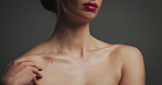 Hands, touch shoulders and skincare in studio, lipstick and natural glow with results on background. Woman, model and collagen for wellness, beauty and cosmetics with makeup, change and dermatology