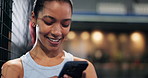 Woman, phone and happy with texting at tennis court for fitness, exercise and contact with web chat. Person, athlete and smartphone at night, smile or mobile app for social network at sports club