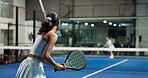 Sports, woman and playing padel on court for match practice, game challenge or serving ball. Night, people and back of tennis player at club for technique training, fitness performance and tournament