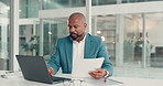 Business, documents and black man in office, laptop and financial agent with tax audit. Mature person, employee and consultant in workplace, pc and email with budget report, accounting and internet