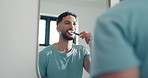 Brushing teeth, oral health or man in bathroom, mirror or morning with grooming routine. Home, dental hygiene or person with toothbrush, wellness or fresh breath with reflection and cleaning mouth