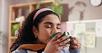 Tea, drinking or happy woman in apartment to relax in lounge for cup of hot chocolate. Cappuccino, smile or excited person enjoying warm beverage or coffee in home for cozy break, latte or caffeine