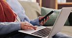 Hands, laptop and typing on sofa, home and e commerce with fintech app, scroll and payment on web. Person, smartphone and computer with online shopping, discount and click with promo code at house
