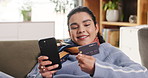 Woman, phone and smile with credit card on sofa, home and e commerce with fintech for payment on web. Person, smartphone and happy with online shopping, discount or digital banking with sale at house