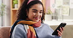 Happy, girl and relax with phone on sofa for weekend break, reading funny ebook and internet news. Smile, woman and smartphone in home for streaming service, social media browsing and watching videos