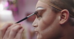 Makeup, drag artist and person with brush getting ready for performance, self expression and show. Beauty, creative and performer backstage with cosmetics, eyeshadow and makeover in dressing room
