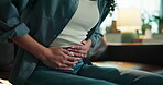 Stomach ache, cramp and period pain with woman on sofa for endometriosis, menstruation and crisis. Abdomen, ovarian fibrosis and emergency with person in living room of home for inflammation