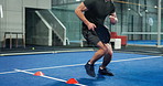 Feet, run and cones for agility training, fitness and practice or balance exercise for workout. Man, drills and paddle for technique, tennis skills and challenge in indoor sports center for control