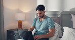 Writer, man and typing on laptop on bed for publication deadline, remote work or upload submission. Freelancer, person and technology in house for editing story, writing headline and editor feedback