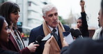 Politician, man and speaking with journalist for news, government policy and opinion in city. Press briefing, politics and talking to reporter for interview, question and announcement for media