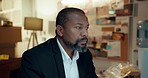 Thinking, investigator and man in station, serious or review of evidence for criminal investigation. Night, mature detective and planning for case, police and black person with duty and working late