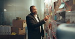 Man, crime board or night with investigation for murder mystery, murder scene or tracking suspect. Male person, officer or detective working late with map for evidence or information on serial killer