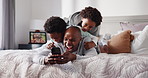 Morning, phone and children jumping on dad in bedroom of home for bonding, having fun or laughing. App, black family or funny with boy kids and single parent father playing on bed in apartment