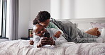 Morning, phone and kids jumping on dad in bedroom of home for bonding, having fun or laughing. App, black family or funny with boy children and single parent father playing on bed in apartment